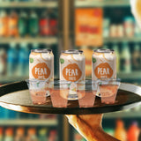 Four blank 5 oz plastic cups filled with juice on serving tray, with pear juice cans behind