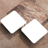 Two 4" Blank Medium Weight Square Coaster, on a light brown marble background