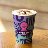 12 oz. Multicolor Recyclable  Paper Cup displaying "Coffee Spot Premium", on a wooden table.