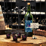 5 oz custom printed plastic cups on wooden barrel, filled with wine, with bottle and Pinot Noir sign.